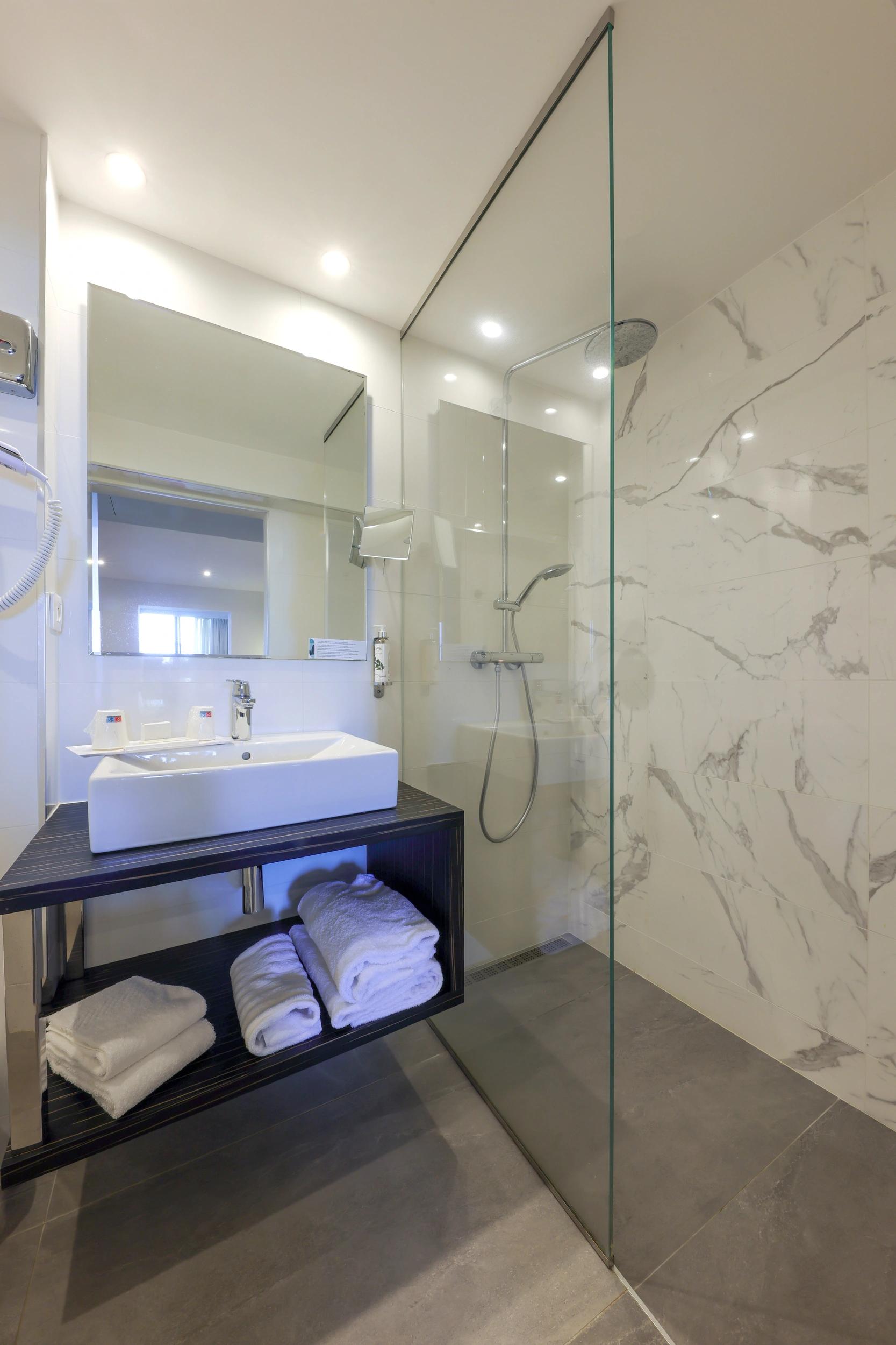 Salle de bain lumineuse et fonctionnelle dans une chambre Supérieure à Calvi avec vue jardin